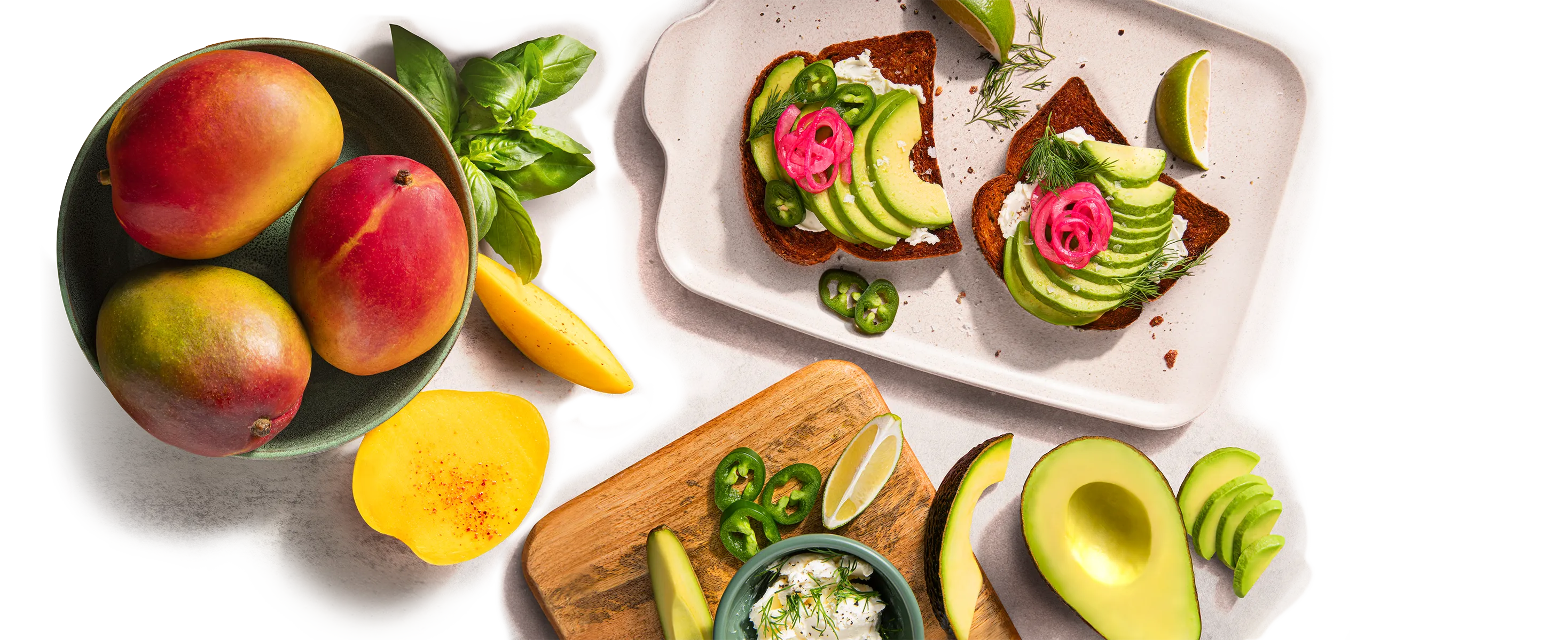 overhead scene of mangos and avocados and avocado toast