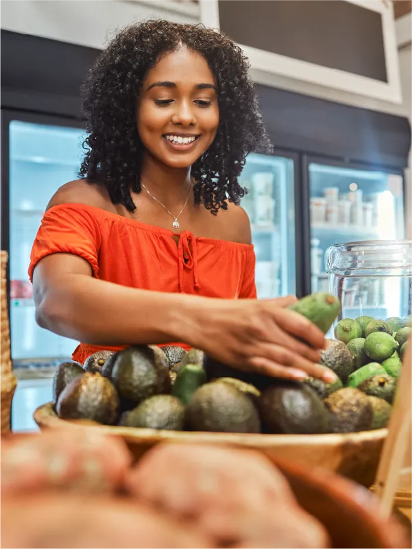 woman shopping for avocados