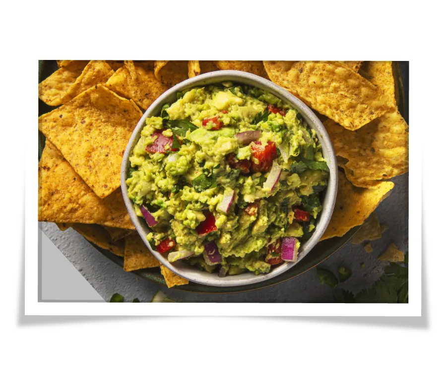 Photo of tortilla chips with a bowl of guacamole