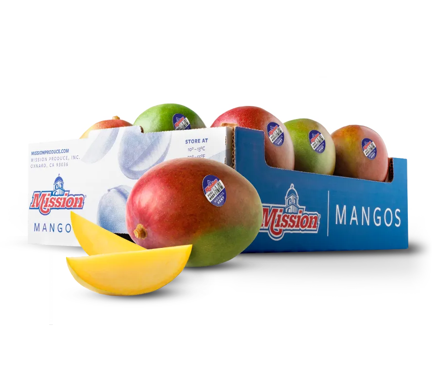 Photo of a carton of mangos with a whole mango and slice of mango in the forefront