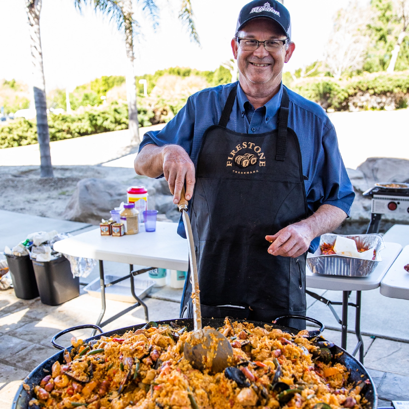 Mission employee making paella